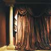 red and gold metallic paint effect walls next to shot silk curtains