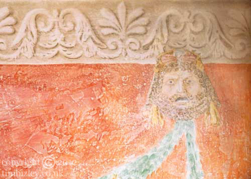 a mask in the Antique Pompeii manner painted on wall