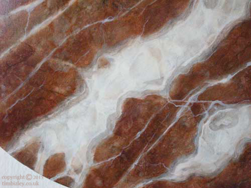red marble effect in greater detail showing veins and inclusions