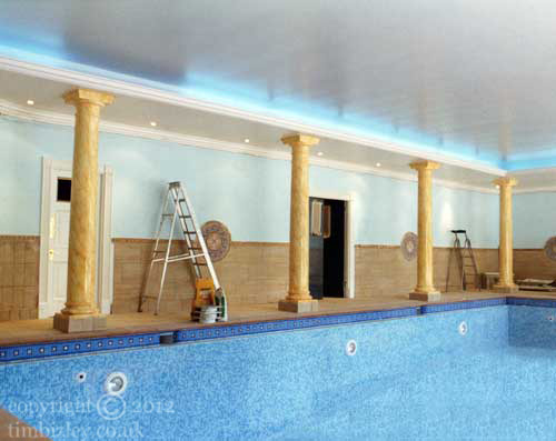 yellow sienna painted faux marbling to swimming pool columns
