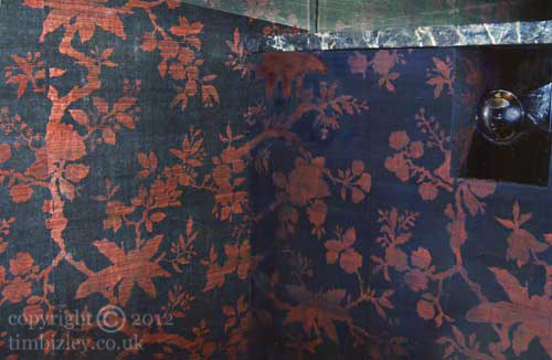 Chinese influenced red and black floral stencilled walls