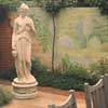 marble statues, plants and flowers mural painted on garden wall