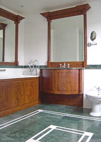  warm coloured faux woodgraining to bathroom units and mirror frames contrasts with cool green marble