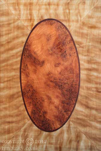 blonde satinwood surrounds an orange burr yew centre created with wood graining paint finish